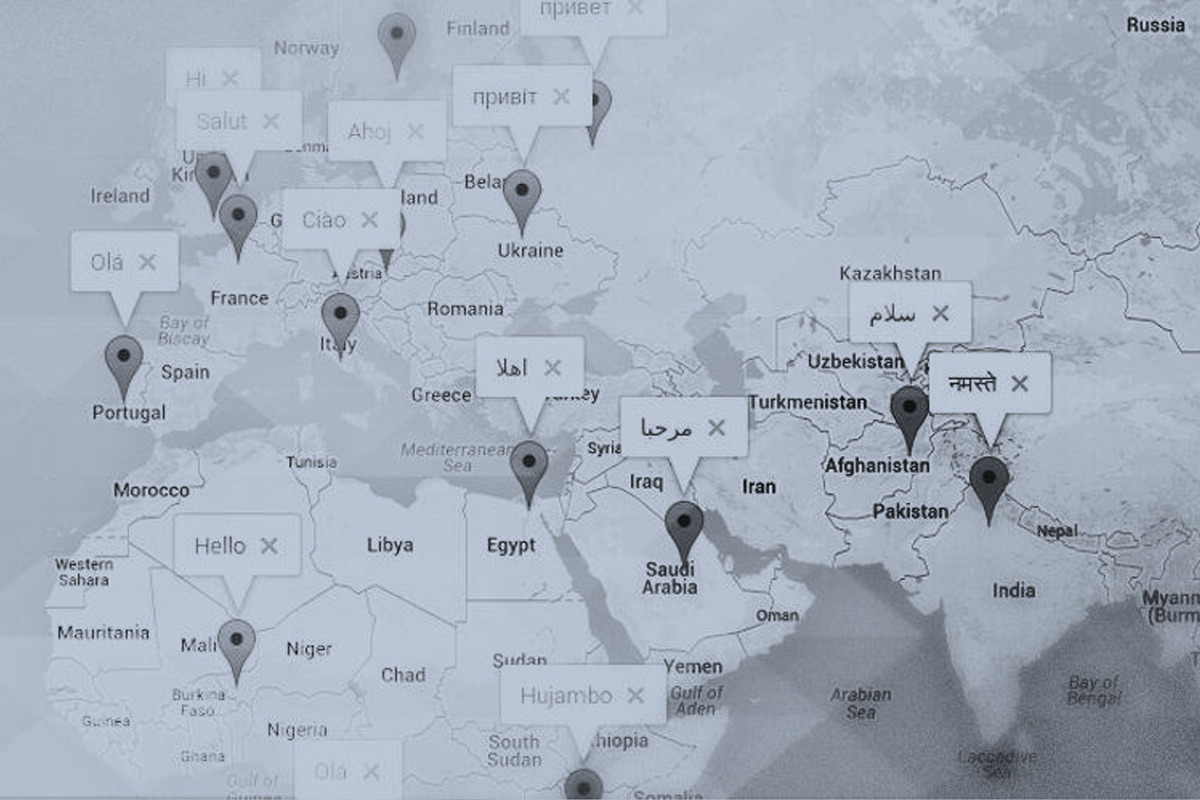Tinted image showing a portion of the world map with translations of the word Hello pinned to multiple locations on the map.